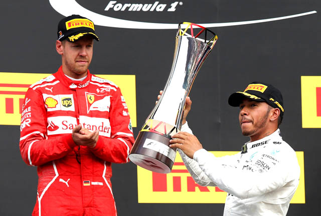 Mercedes' Lewis Hamilton celebrates with the trophy after victory in the 2017 Belgian Grand Prix alongside second-placed Ferrari driver Sebastian Vettel in Spa-Francorchamps, Belgium, on Sunday (Reuters photo by Francois Lenoir)